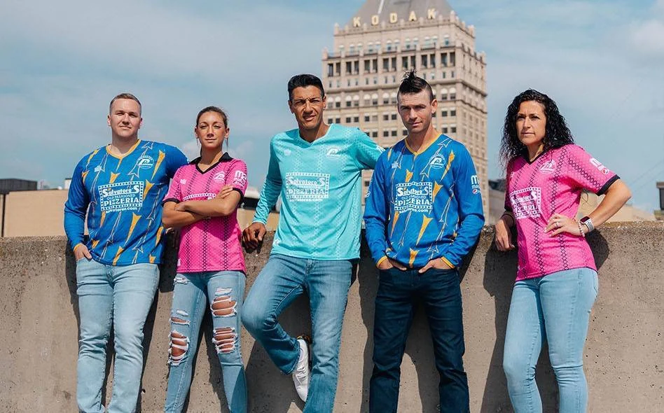Rochester Lancers representatives wearing modern blue, turquoise and pink Admiral kits